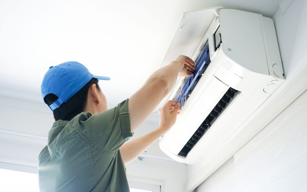 Air conditioning technician maintaining an indoor mini split system in Flagstaff, AZ